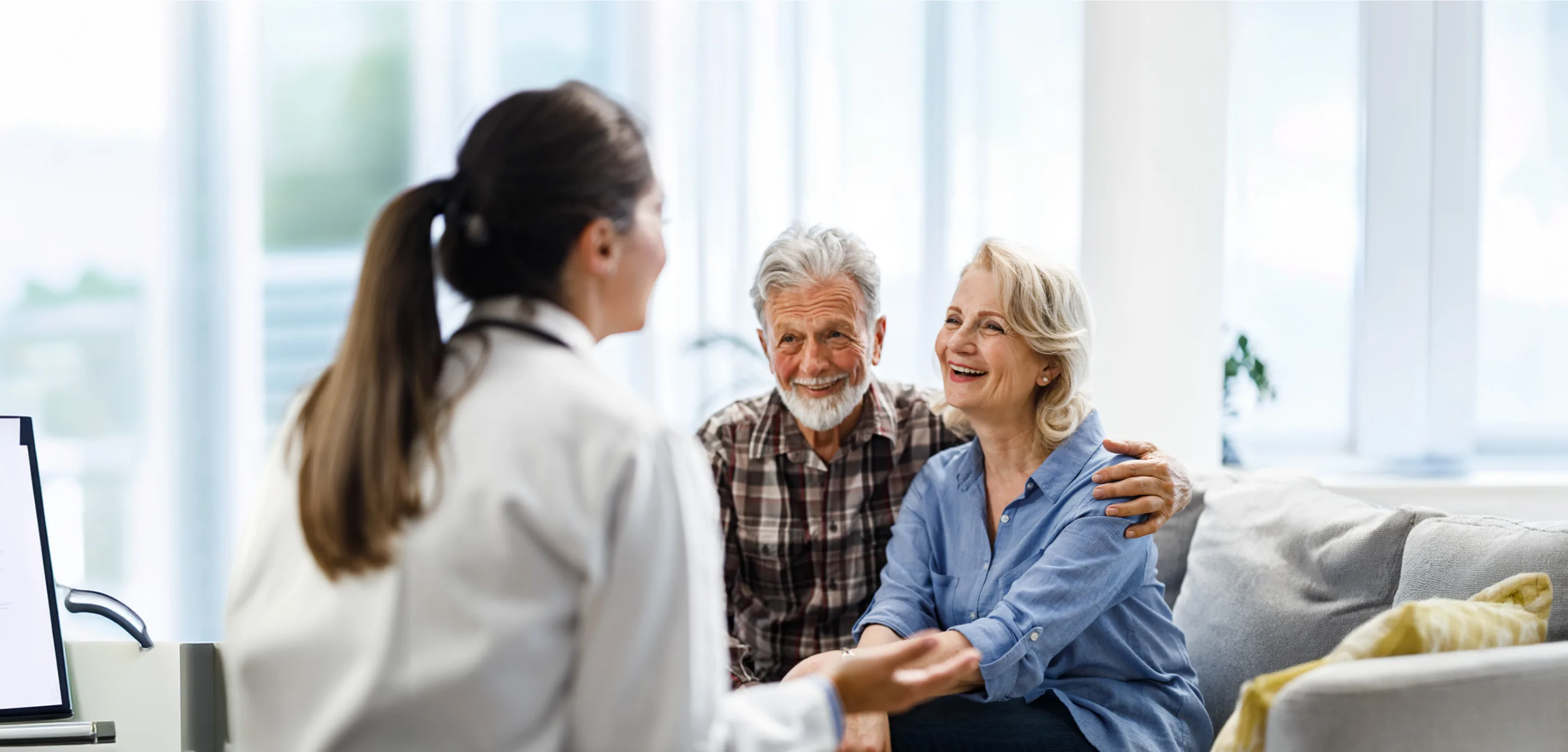 old couple reviewing speaking with medical professional