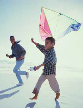 Picture of young boy and mother flying kite.