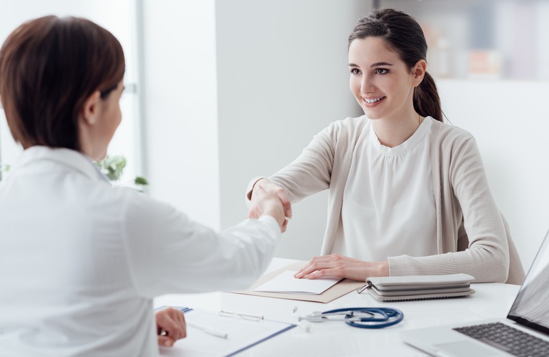 Doctor and patient shaking hands.