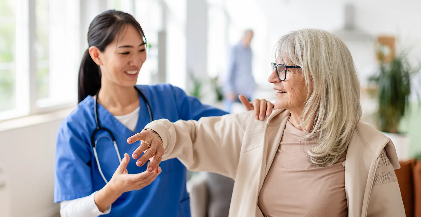 A woman smiling while getting examined by a provider