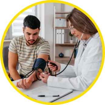 Dr taking patients blood pressure in examine room