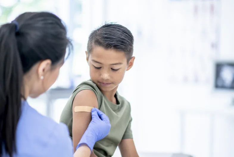Kid getting band aid over shot area