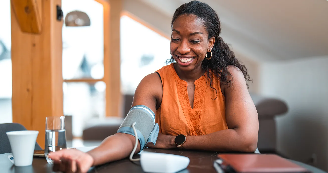 photo of a woman smiling & speaking with a medical professional in-office