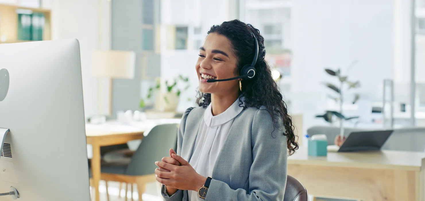 photo of a woman smiling & speaking with a medical professional in-office