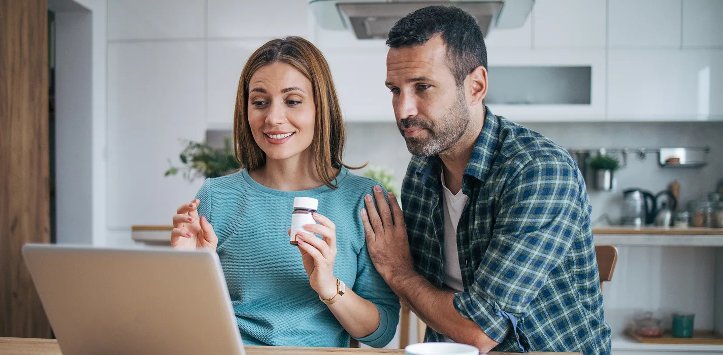 older black couple smiling & dancing at home