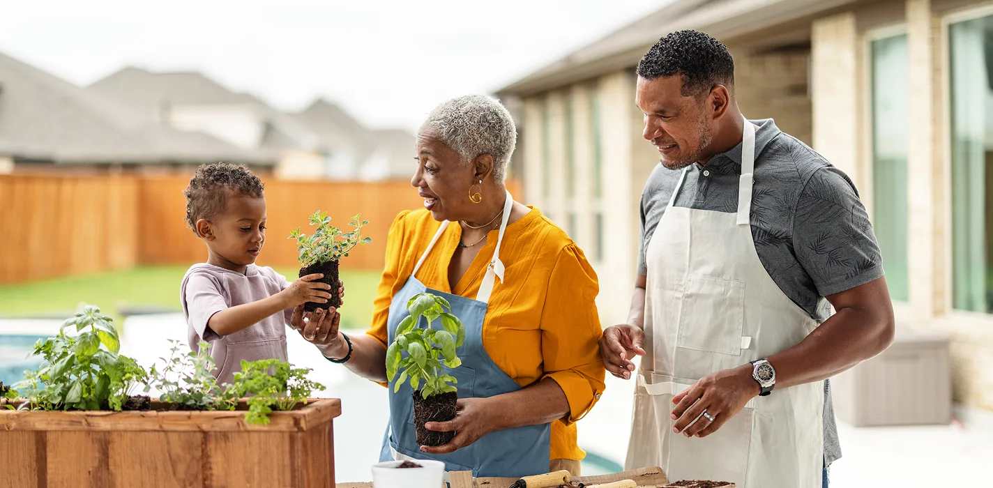 older black couple smiling & dancing at home