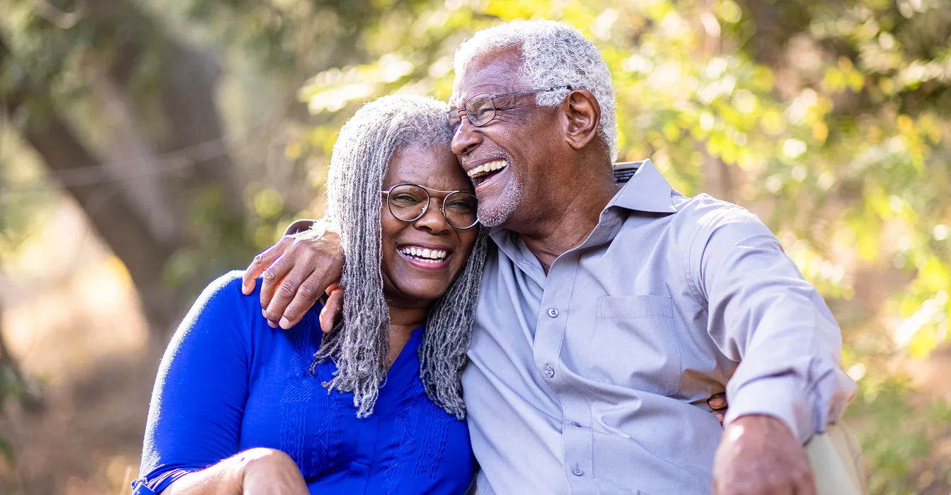young black African American couple smiling, showing their bandages after getting vaccinated