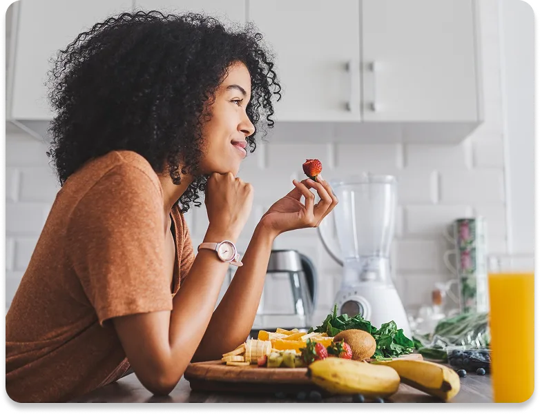 picture of a man smiling while he eats strawberries & yogurt