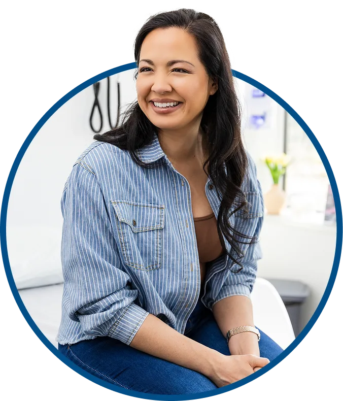 picture of a woman smiling while sitting on an exam table