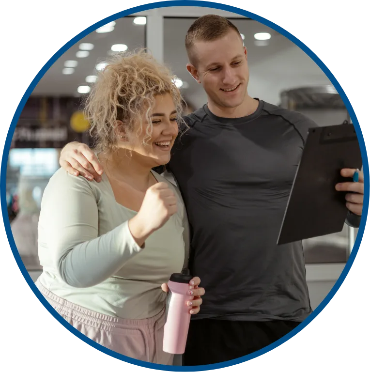 woman making progress in gym with her trainer