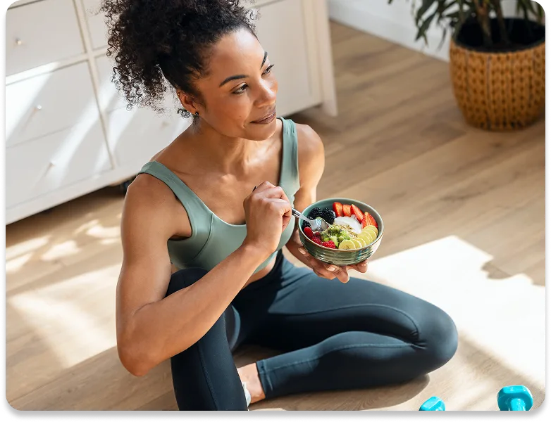 picture of a man smiling while he eats strawberries & yogurt