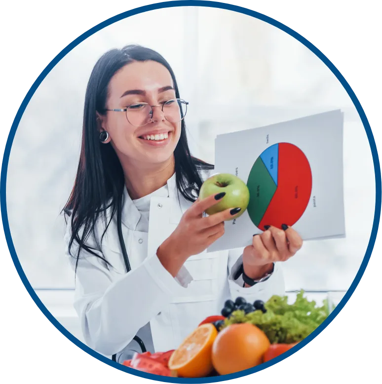 nutritionist holding up apple to food chart