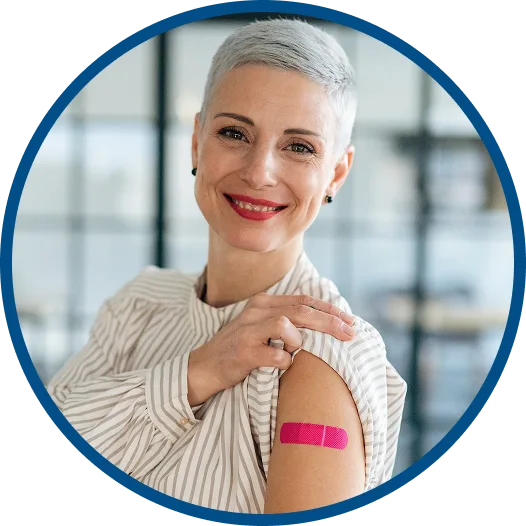 Smiling woman with a bandage on her arm after receiving a vaccine
