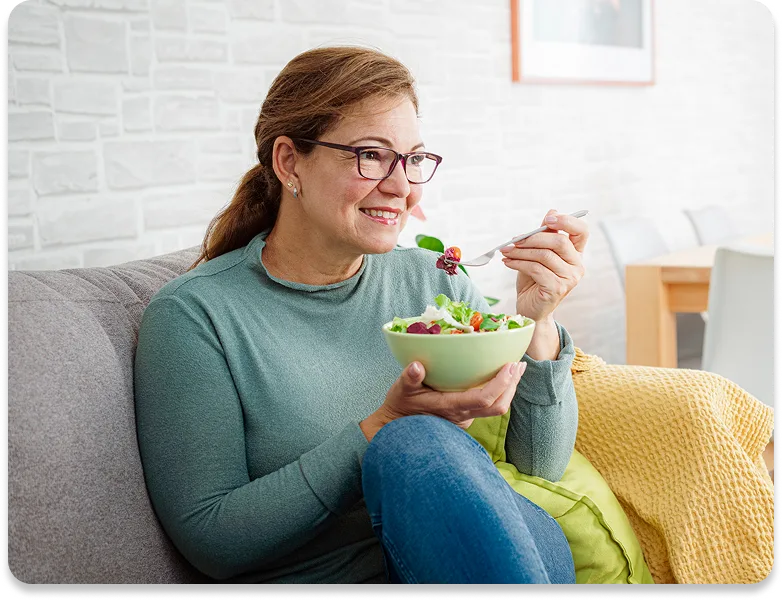 picture of a man smiling while he eats strawberries & yogurt