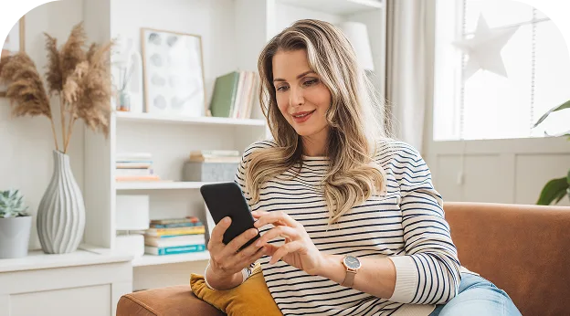 image of a middle-aged checking her phone on the couch