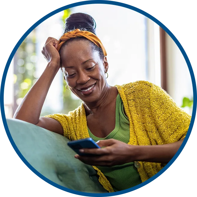 woman experiencing a hot flash & pointing a fan at herself