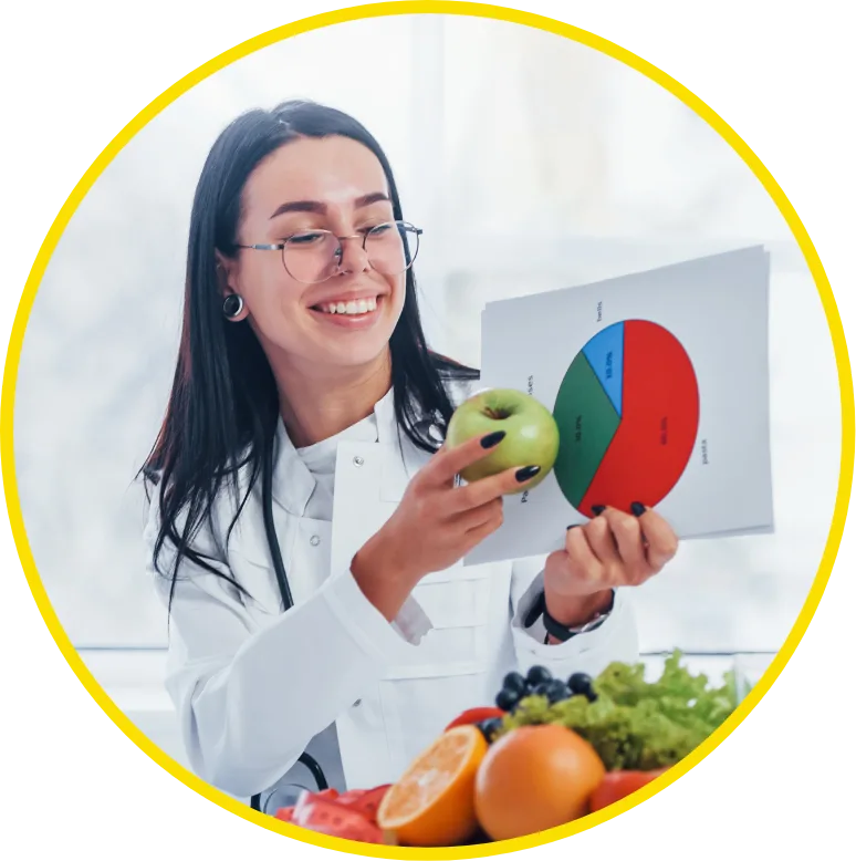 nutritionist holding up apple to food chart