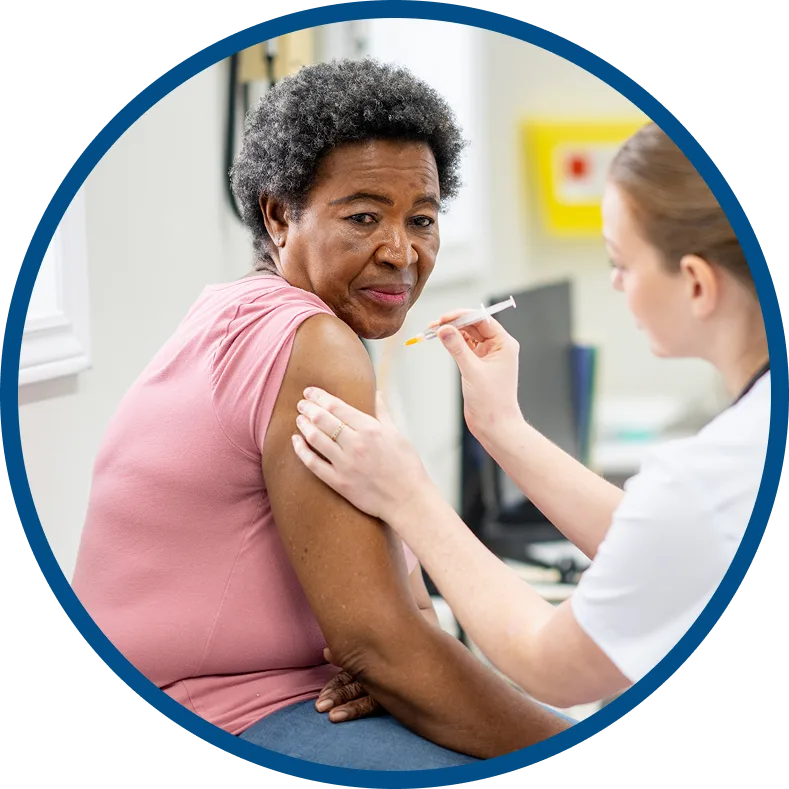 Nurse preparing to administer a vaccine to an older adult