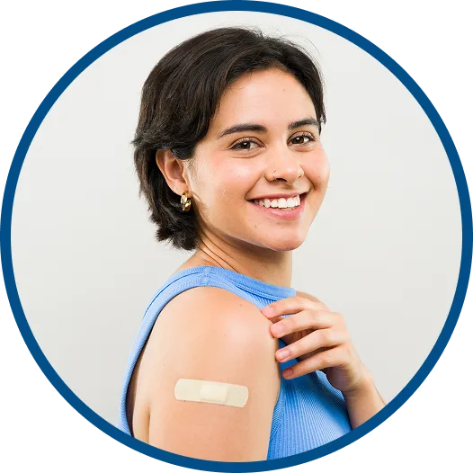 Smiling woman with a bandage on her arm after receiving a vaccine