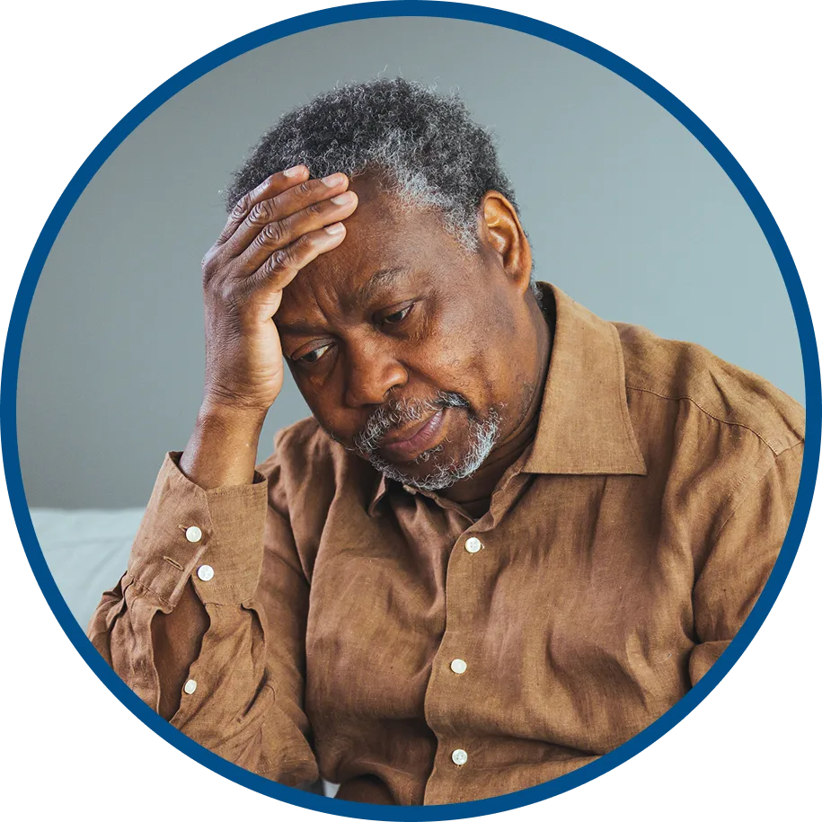 an older man sick with pneumonia holds his head