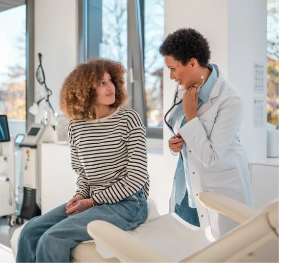 woman with woman dr in examining room talking