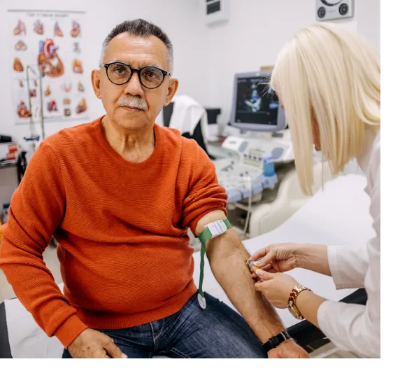 Elderly man in doctors office getting iv for blood test by doctor