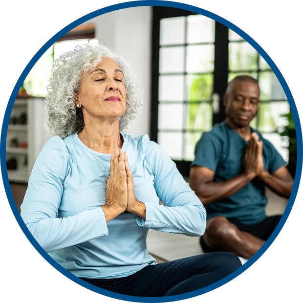 Couple sat doing yoga